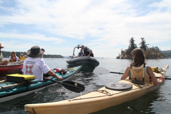 RCMP officers warn protesters near Grace Islet on Friday.