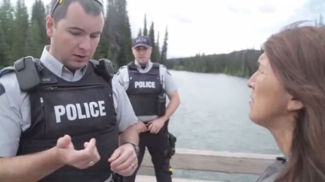 RCMP at the Unist'ot'en camp speak with Freda Huston, July 2015.